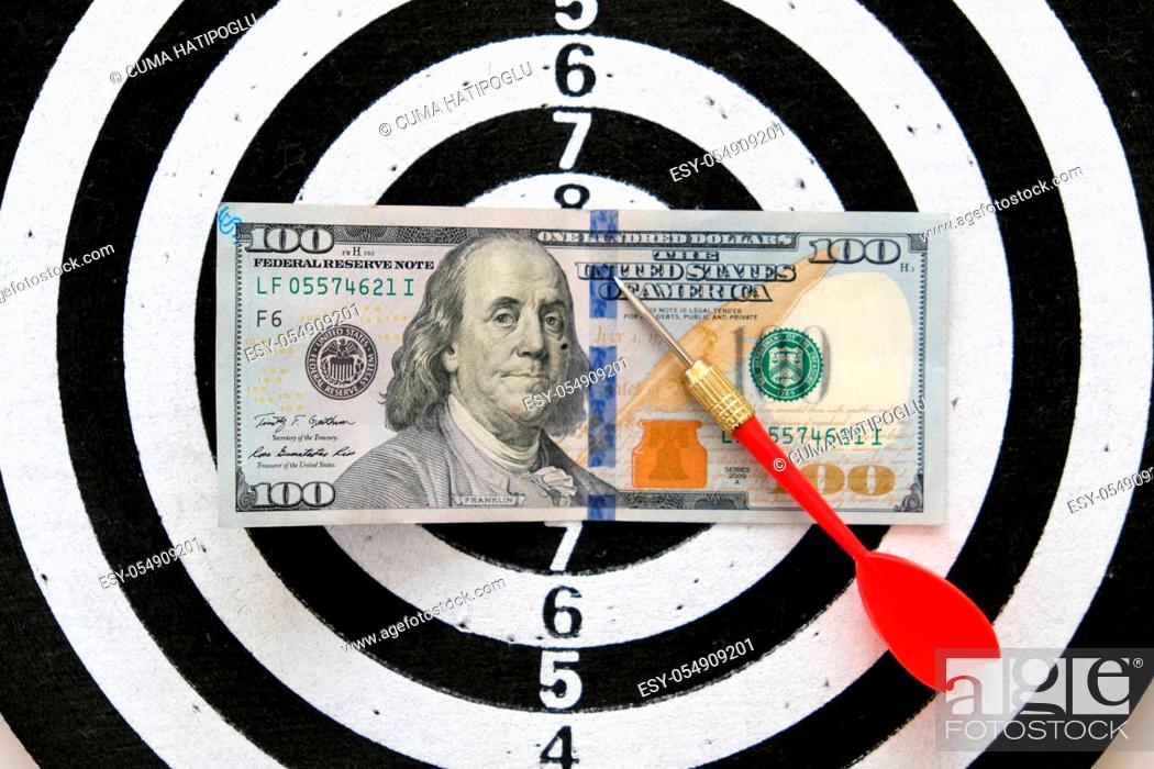 Stock Photo: 100 us dollar and dart arrows, dart board and 100 usd dollar,.