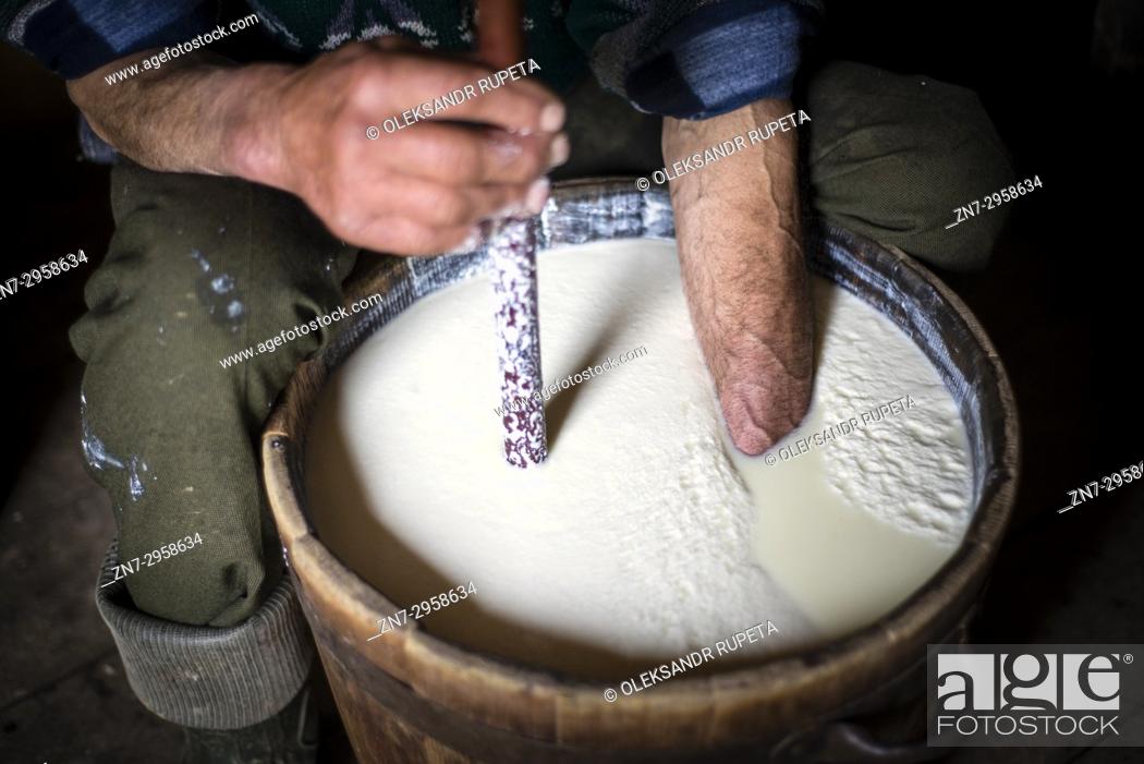 Stock Photo: Shepherds make sheep's milk cheese. Late spring, when shepherds go to Carpathian mountain valleys all villagers come to celebrate it together.
