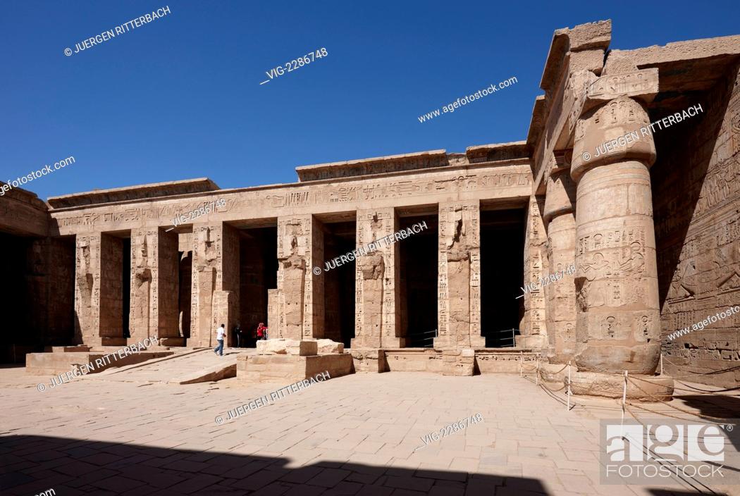 Stock Photo: EGYPT, LUXOR, 29.03.2010, Columns of god Osiris at western colonade in second yard of Mortuary Temple of Ramesses III at Medinet Habu, Luxor, Egypt.