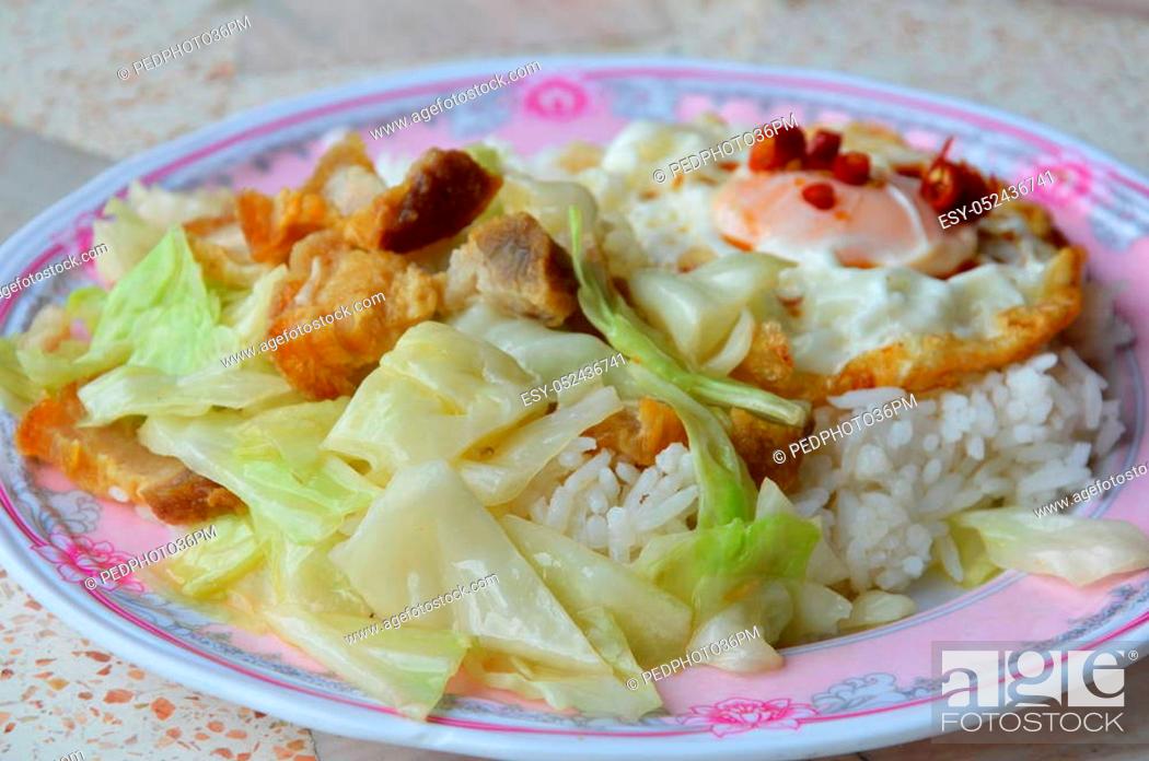 Stock Photo: stir fried cabbage with crispy pork and egg on rice.