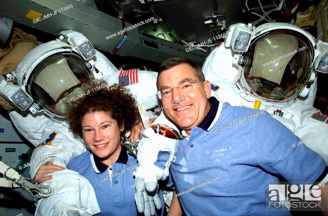 Stock Photo: Astronauts James S. Voss and Susan J. Helms, STS-102 mission specialists, are pictured with their Extravehicular Mobility Unit (EMU) space suits on the mid deck.
