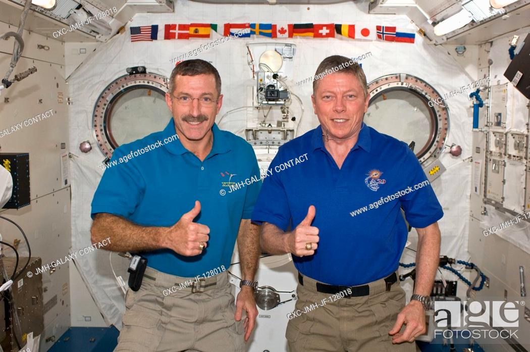 Stock Photo: NASA astronauts Dan Burbank (left), Expedition 30 commander; and Mike Fossum, Expedition 29 commander, pose for a photo in the International Space Station's.