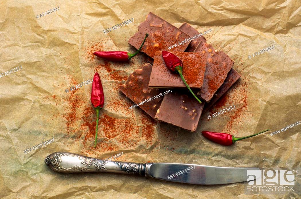 Stock Photo: Spice red chilli peppers and chocolate, selective focus.