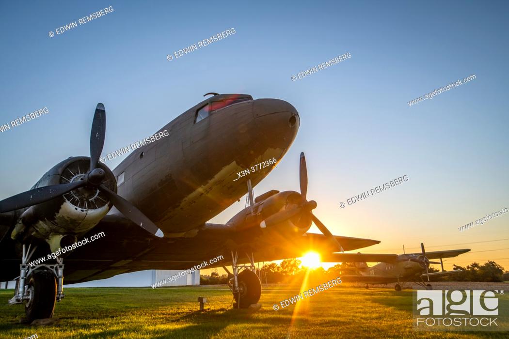 Stock Photo: Sunsetting behind DC-3 sitting outside of Massey Airport, Massey, MD.