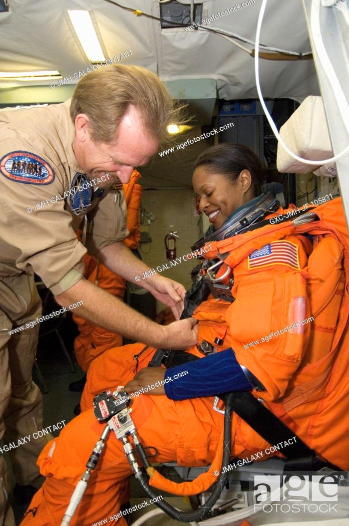 Stock Photo: Astronaut Joan E. Higginbotham, STS-116 mission specialist, gets help with the final touches on her training version of a shuttle launch and entry suit prior to.