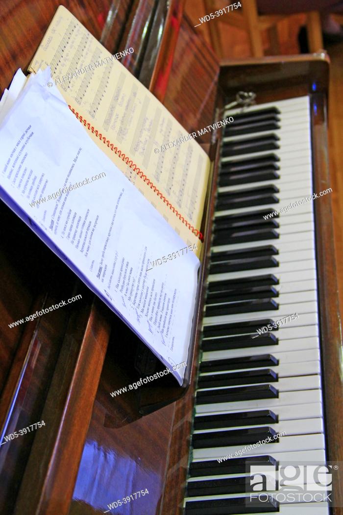 Photo de stock: Piano with notes are ready to play. Keyboard musical instrument. Notes for playing on piano. Music concept.