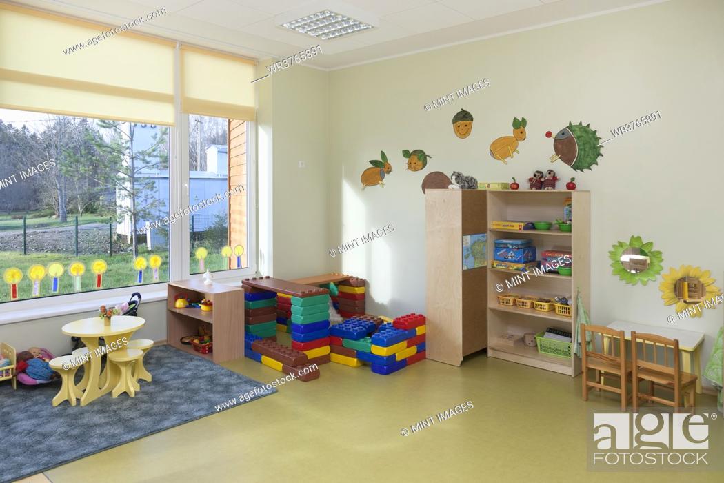 Stock Photo: Modern children's day care or pre-school building, open indoors play area.