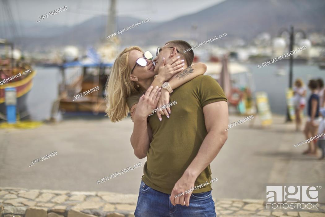 Stock Photo: Happy young couple kissing, Russian ethnicity, Hersonissos, Crete, Greece.