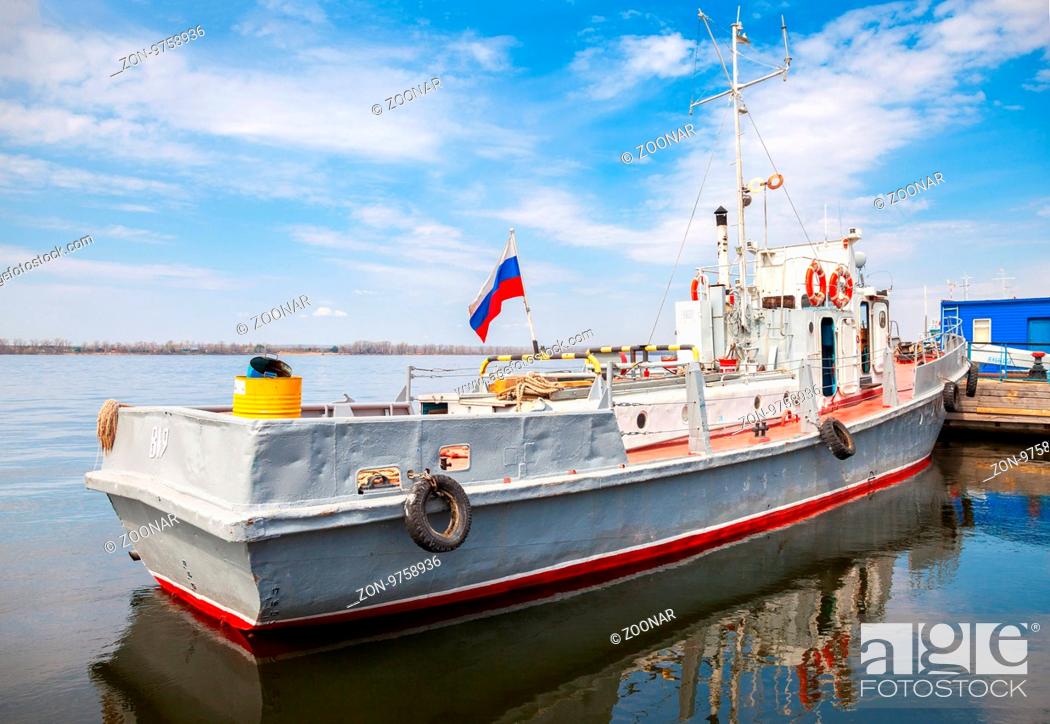 Stock Photo: SAMARA, RUSSIA - MAY 1, 2015: The small ship is at the quay wall of the river port in sunny day.