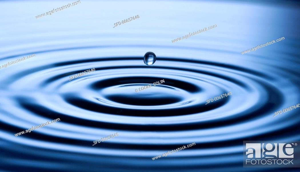 Stock Photo: Drop of water falling into water.