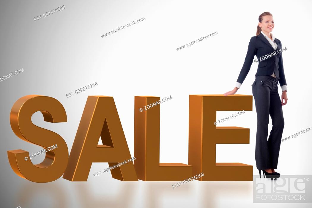 Stock Photo: Woman standing next to SALE word.
