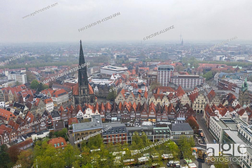 Stock Photo: 30 April 2021, North Rhine-Westphalia, Münster: A view of the Prinzipalmarkt with the St. Lamberti church (taken with a drone).