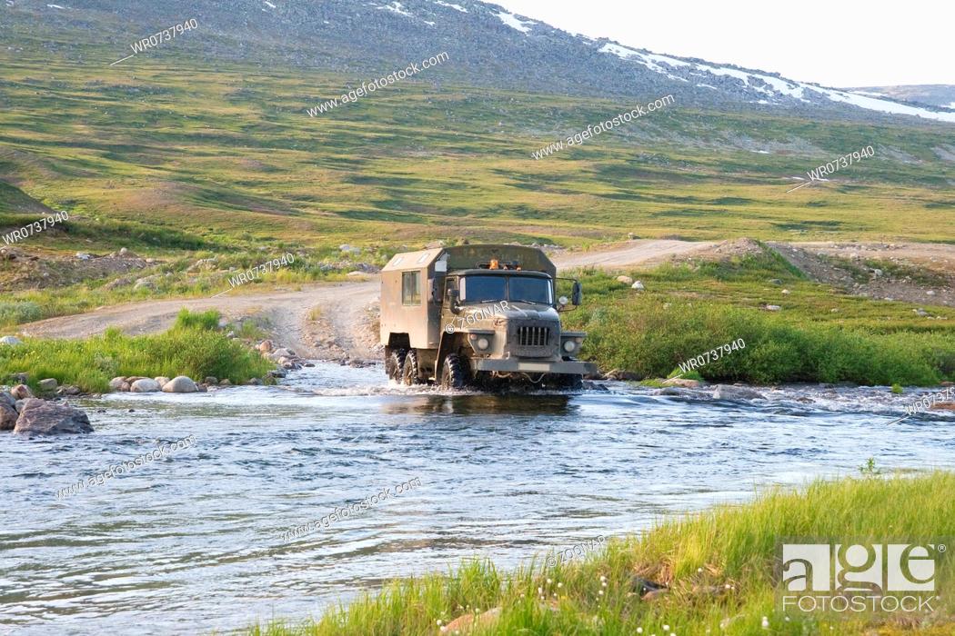 Stock Photo: Russian truck Ural crossing a small river.