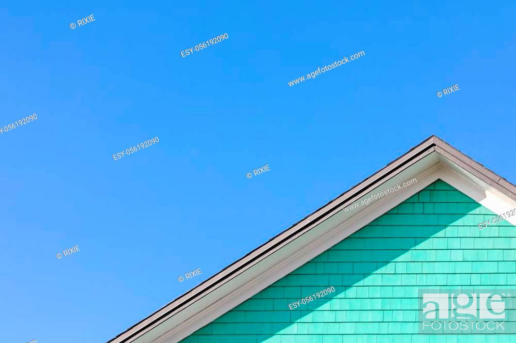 Stock Photo: Colourful rooftop and blue sky. The traditional houses of the Magdalen Islands, Canada. Peppermint green, blue and white composition with space for text.
