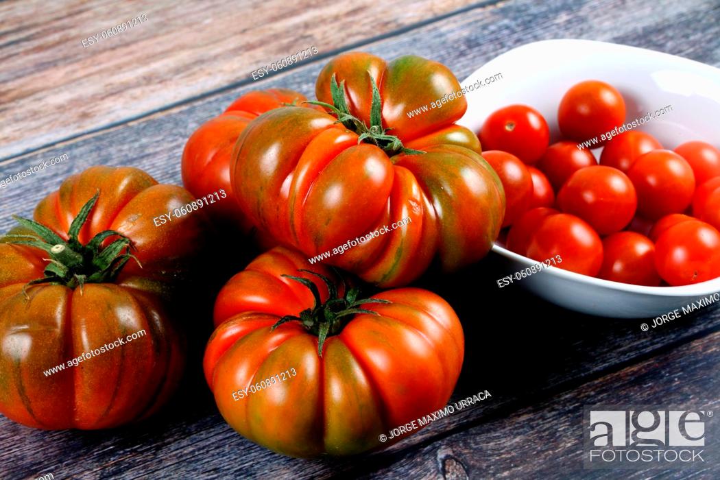 Stock Photo: Variety of tomatoes on wooden board.