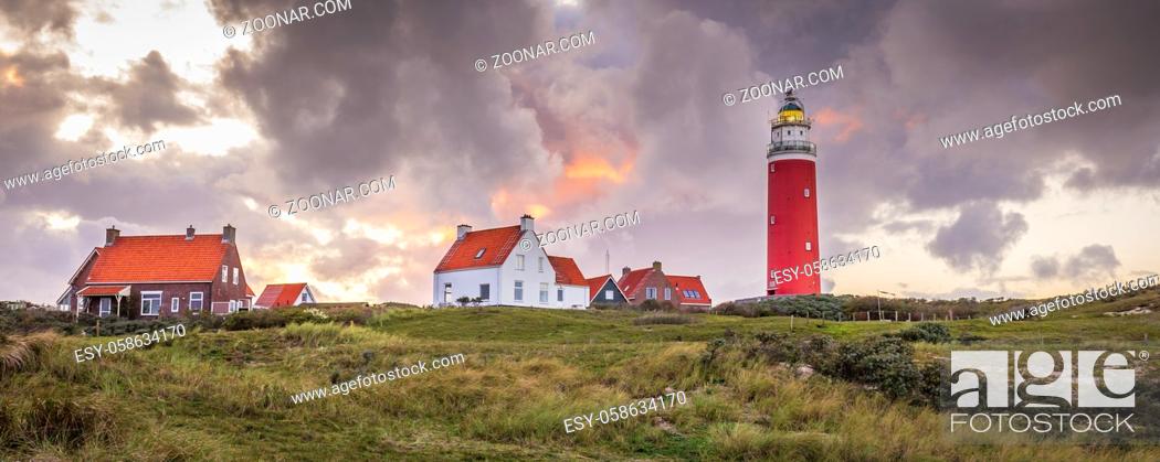 Stock Photo: Landscape with scenic view of Lighthouse during sunset with rainy clouds at Waddenisland Texel, North Holland, Netherlands.