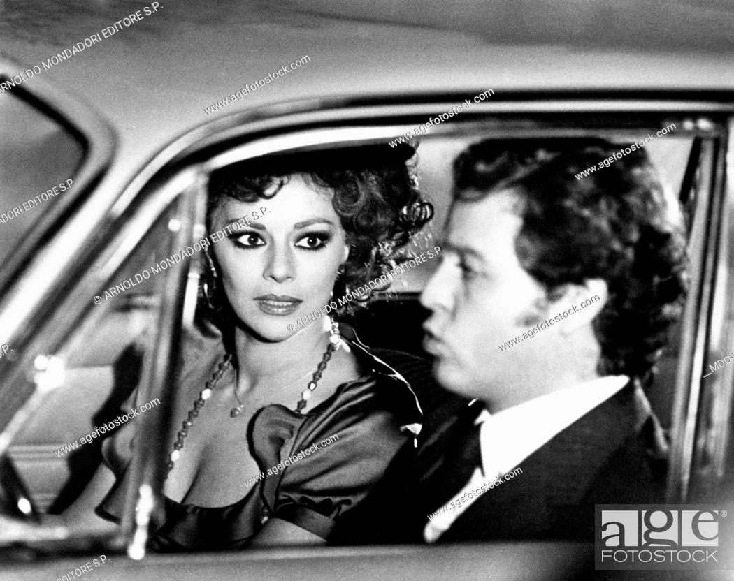 Stock Photo: Giovanna Ralli and Renato Pozzetto in To Love Ophelia. Italian actress Giovanna Ralli and Italian actor Renato Pozzetto sitting in a car in the film To Love.