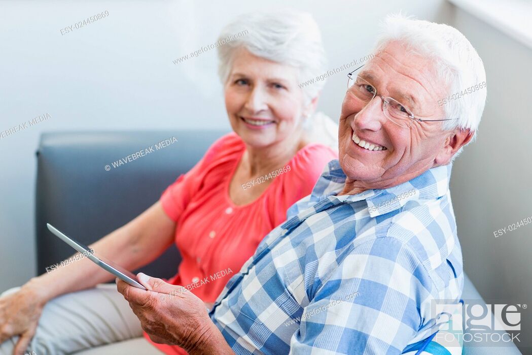 Stock Photo: Senior couple using tablet.