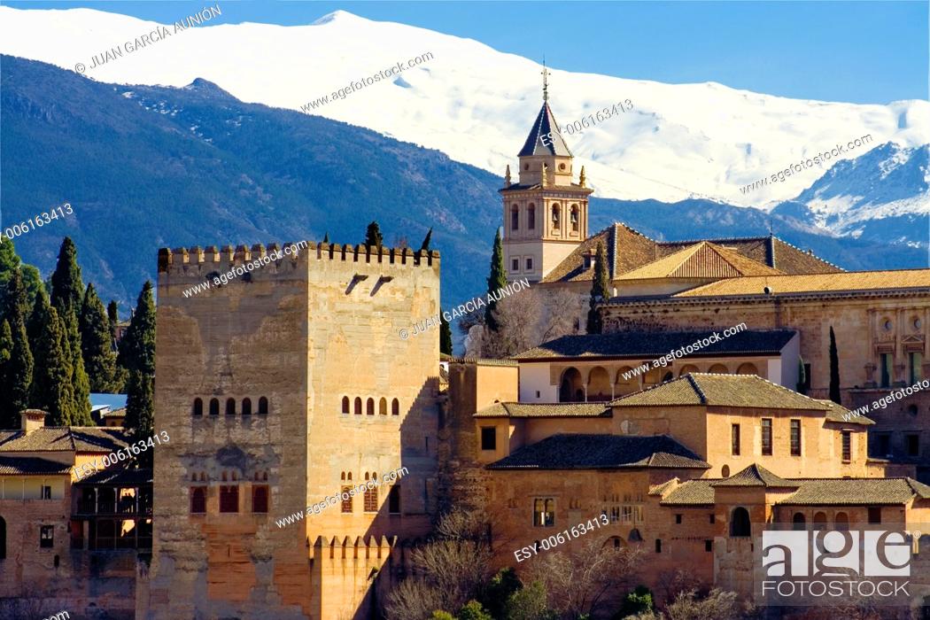 Stock Photo: The Alhambra of Granada in Spain with Sierra Nevada snowy mountains as backgorund . Photo taken from the Albaicin, the moorish district of Granada.