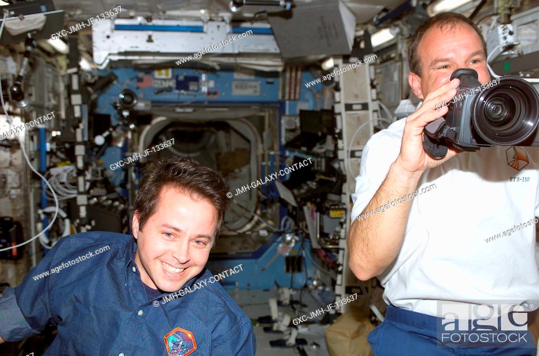 Stock Photo: Astronauts Michael J. Bloomfield (right), STS-110 mission commander, and Daniel W. Bursch, Expedition Four flight engineer.