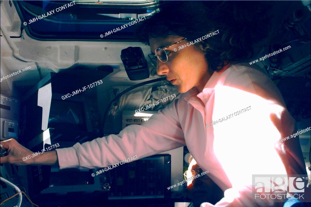 Stock Photo: Operating at a control panel on Endeavour's aft flight deck, astronaut Nancy J. Currie works with the robot arm prior to mating the 12.