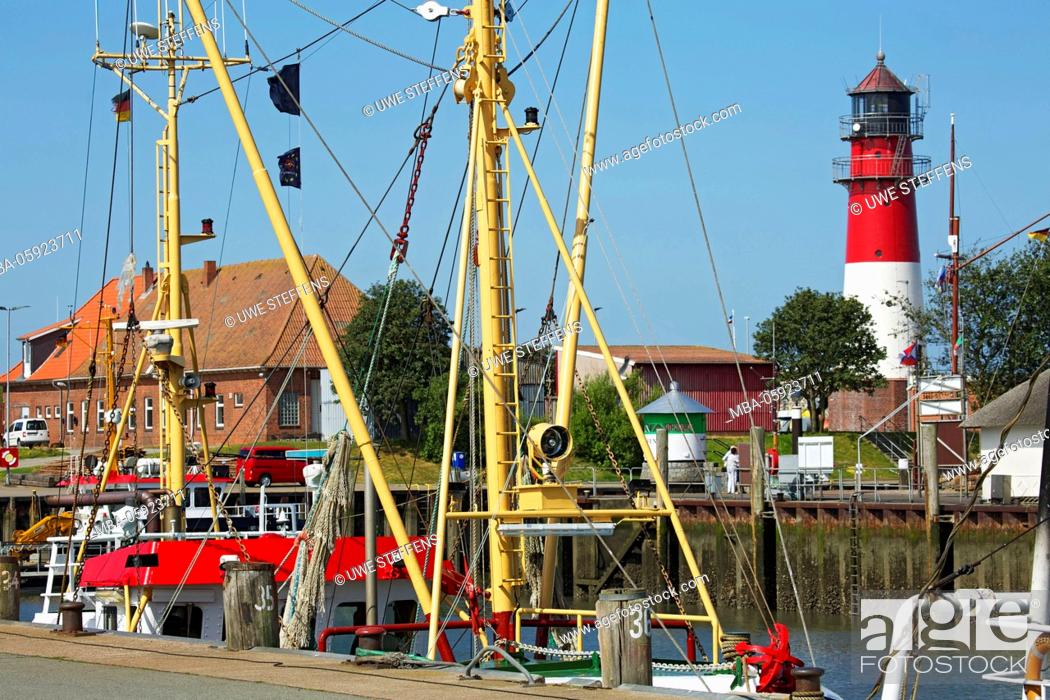 Stock Photo: Cutters in the harbour of Büsum in front of the lighthouse,.