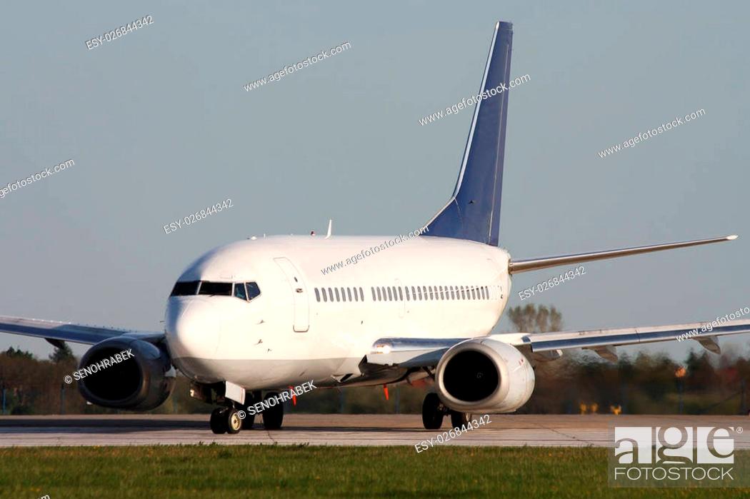 Stock Photo: White airplane preparing for takeoff from the airport.
