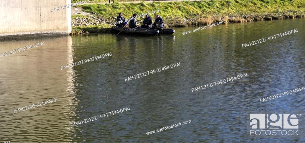 Stock Photo: 27 December 2022, Bavaria, Nuremberg: Divers search for clues under a bridge. Police have begun searching the Main-Danube Canal near Nuremberg in the search for.
