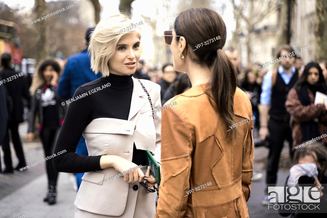 Stock Photo: Street Style - Paris Fashion Week Womenswear Fall/Winter 2019/2020, Xenia Overdose (left) wearing a decorated cream blazer, black turtleneck top.