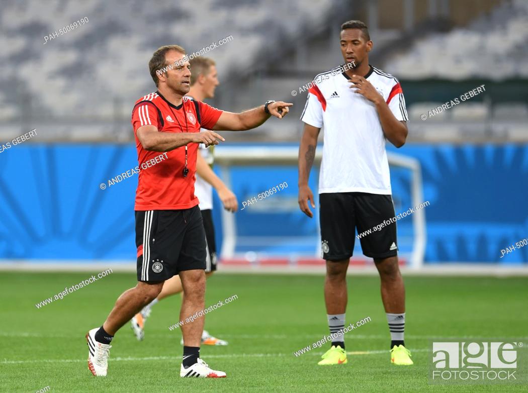 Stock Photo: Assistant coach Hansi Flick and Jerome Boateng (R) seen during the German national soccer team training session at the Estadio Mineirao in Belo Horizonte.