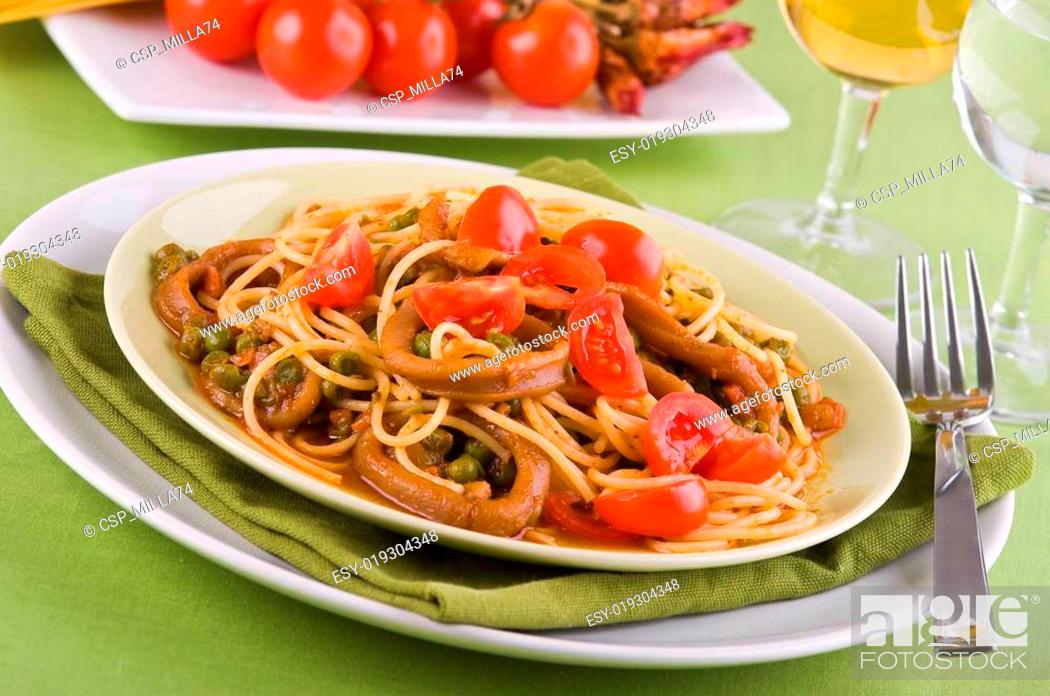 Stock Photo: Spaghetti with squids, peas and cherry tomatoes.