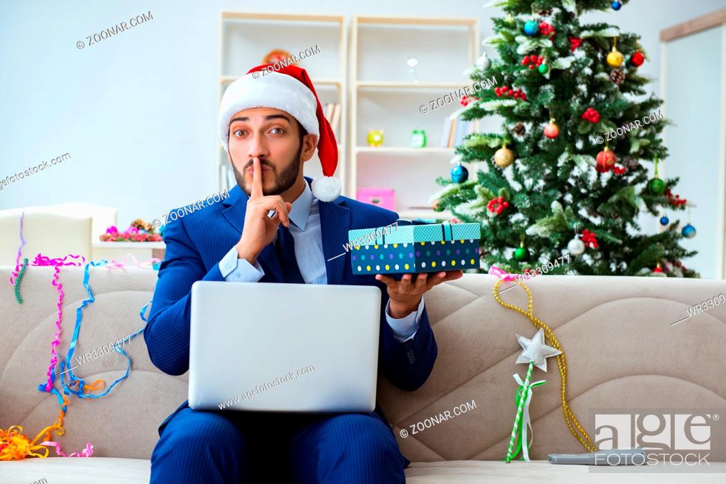Stock Photo: Businessman working at home during christmas.
