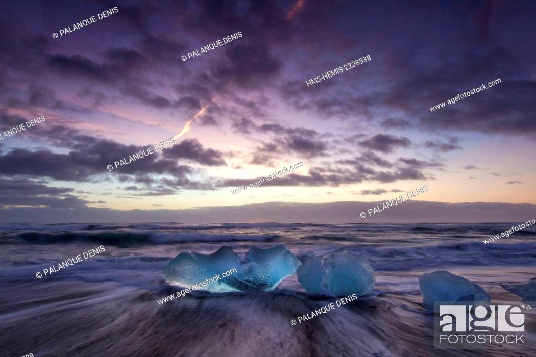 Stock Photo: Iceland, South coast, Jökulsa beach icebergs rejected by the sea on the beach of black sand, sunset.