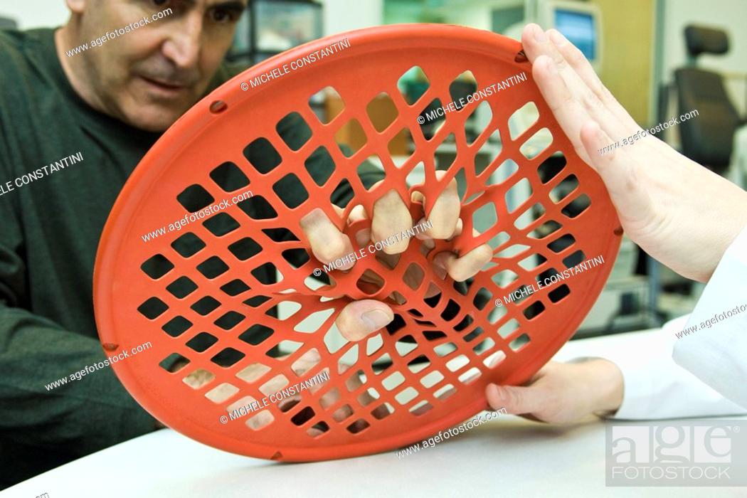 Imagen: Patient using hand exercise web for occupational therapy treatment.