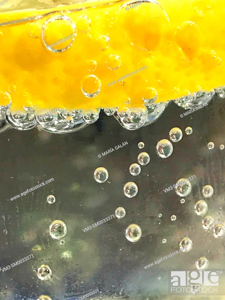 Stock Photo: Slice of lemon floating in sparkling water. Close view.