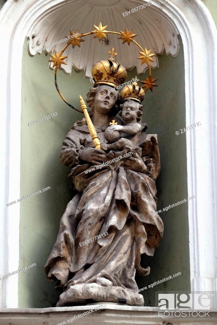 Stock Photo: Virgin Mary with baby Jesus, statue on the house facade in Graz, Styria, Austria.