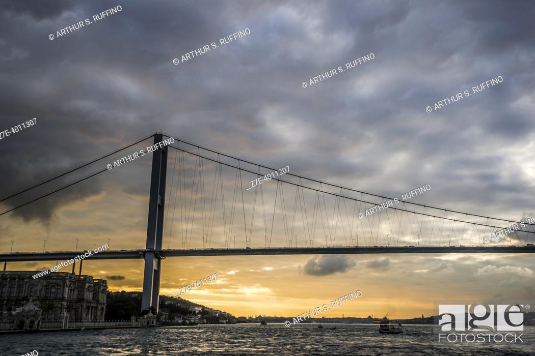 Stock Photo: Bosphorus Bridge spanning over Bosphorus Strait connecting Europe and Asia. Bosphorus Sunset Cruise on an overcast day. Istanbul, Türkiye (Republic of Türkiye).