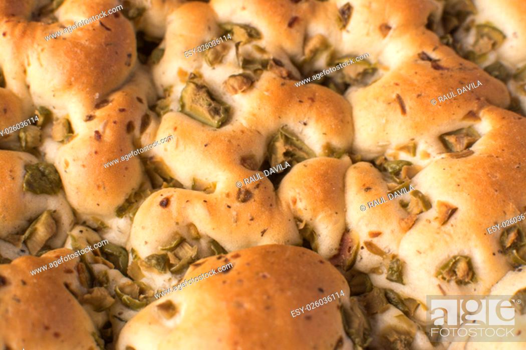 Stock Photo: The focaccia is a traditional loaf - bread from the Italian cuisine and this is closely related to the pizza. in this picture you can see the texture and the.