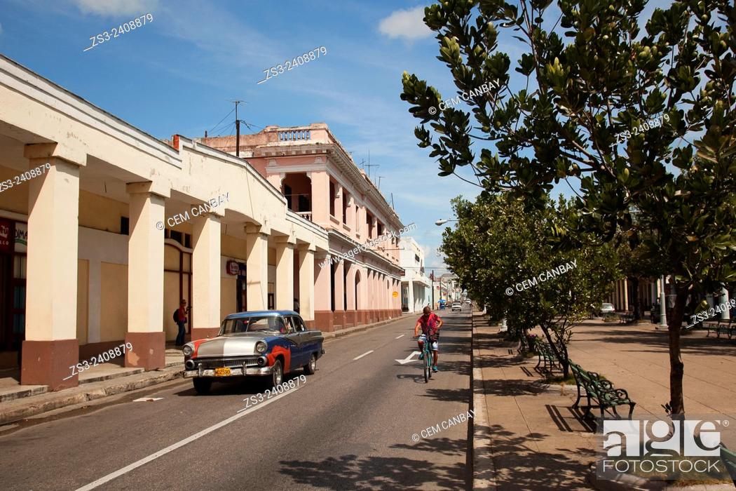 Stock Photo: Car and bike in the main avenue Prado at the town center, Cienfuegos, Cienfuegos Province, Cuba, West Indies, Central America.