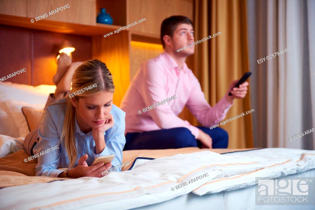 Stock Photo: relaxed and happy young couple in modern hotel room.