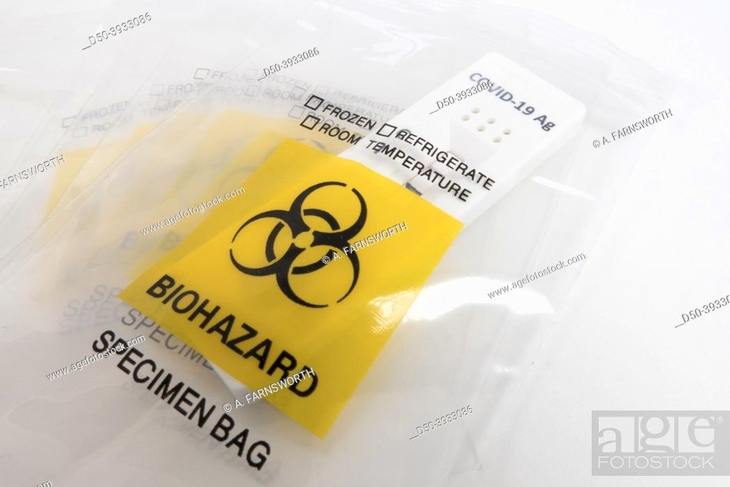 Photo de stock: A biohazard plastic bag and a Covid-19 self test.