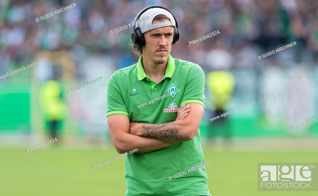 Stock Photo: Bremen's Max Kruse stands on the pitch listening to music before the match of Werder Bremen against SF Lotte in the first round of the DFB Cup at the FRIMO.