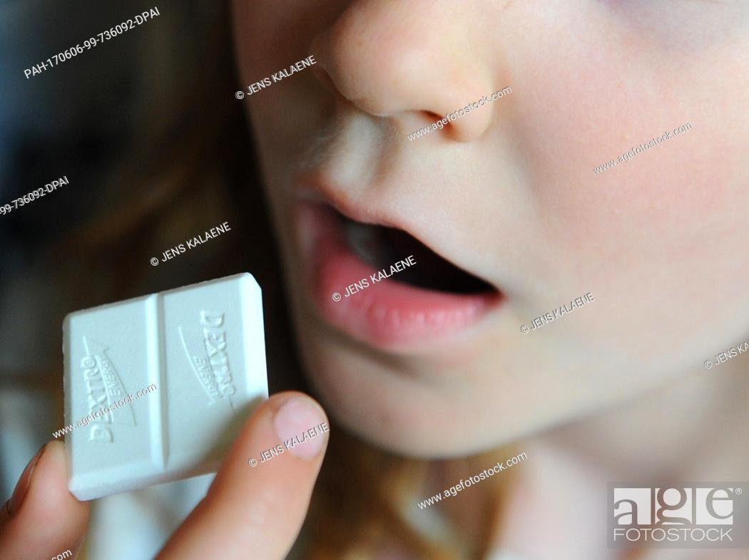 Stock Photo: FILEÂ - A file picture dated 26 April 2011 shows a girl bringing a piece of Dextro Energy to her mouth, in Berlin, Germany.