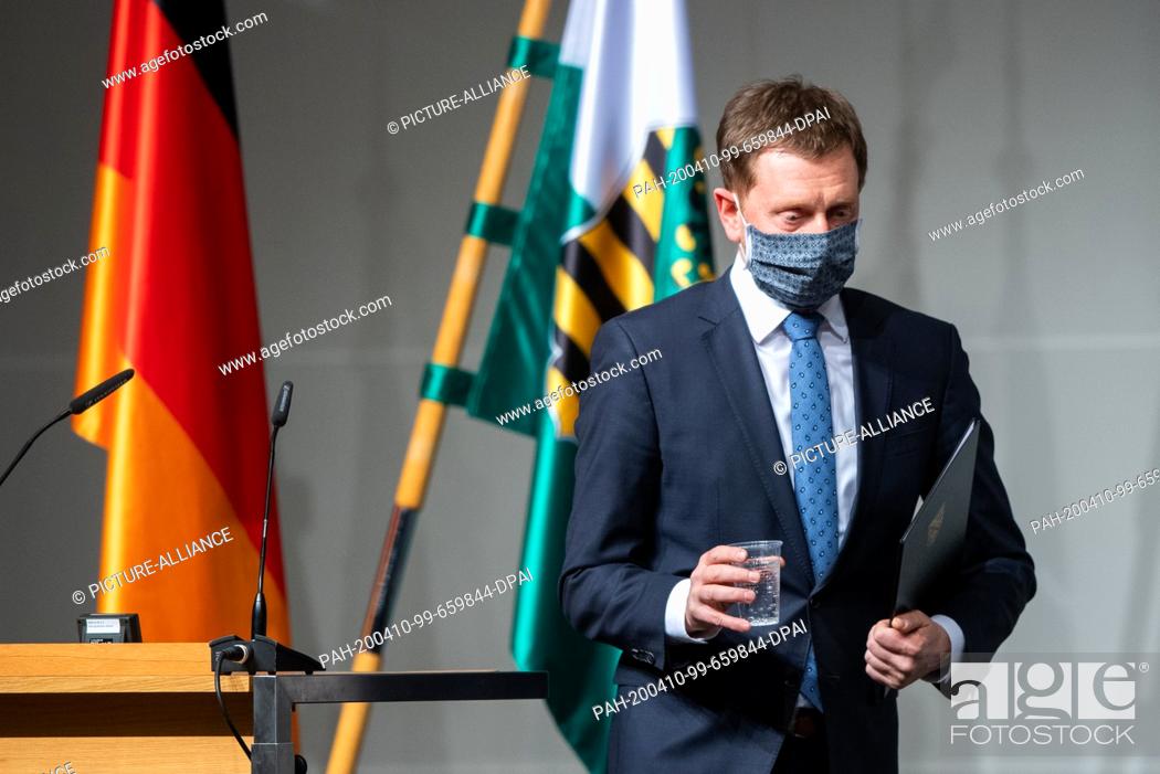 Stock Photo: 09 April 2020, Saxony, Dresden: Michael Kretschmer (CDU), Prime Minister of Saxony, leaves the lectern after his speech during a special session of the Saxon.