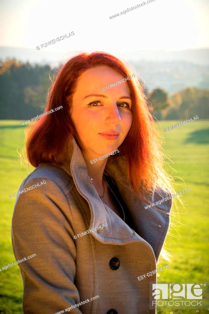 Stock Photo: An attractive young woman in autumn in the evening light.