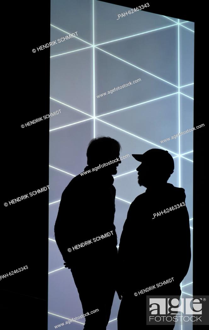 Stock Photo: American artist Pierce Warnecke (l) and Canadian Matthew Biederman in the shadows of their installation work at the Werkleitz Festival in Halle (Saale), Germany.