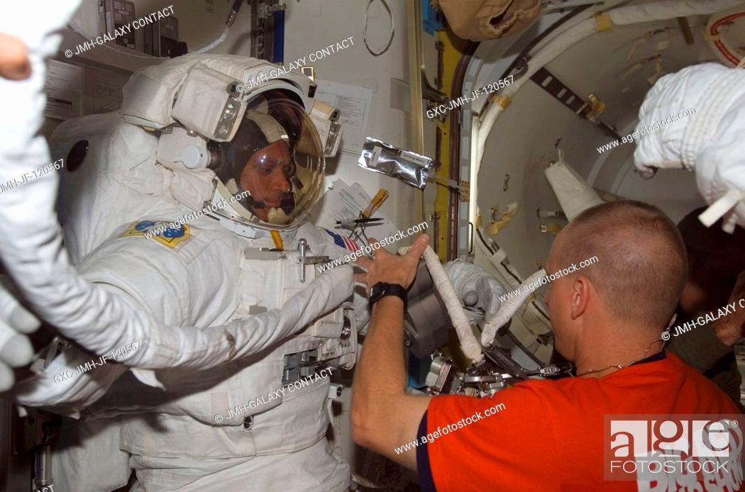 Stock Photo: Attired in his Extravehicular Mobility Unit (EMU) spacesuit, astronaut John Danny Olivas, STS-117 mission specialist, prepares for the mission's third session.