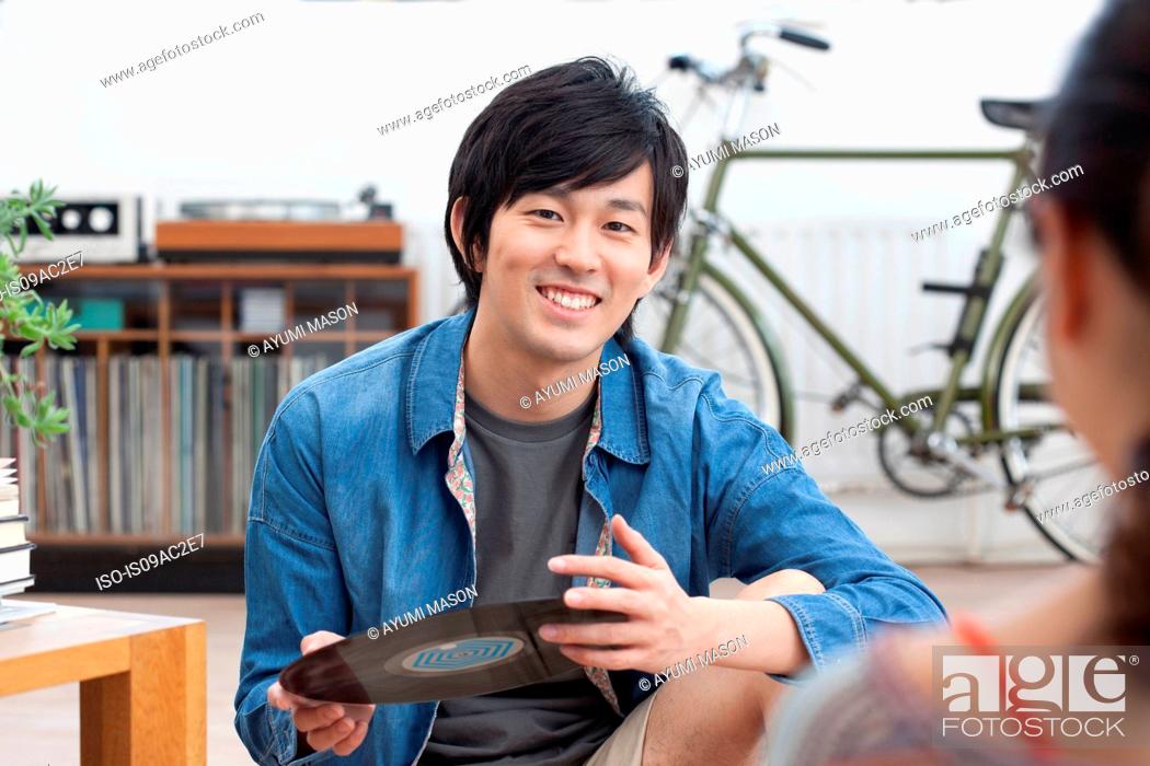 Stock Photo: Young man holding vinyl record.