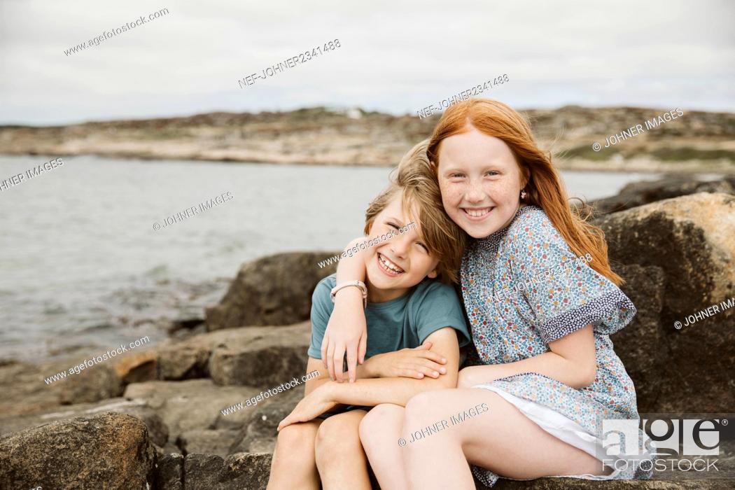 Stock Photo: Brother and sister playing at seaside.
