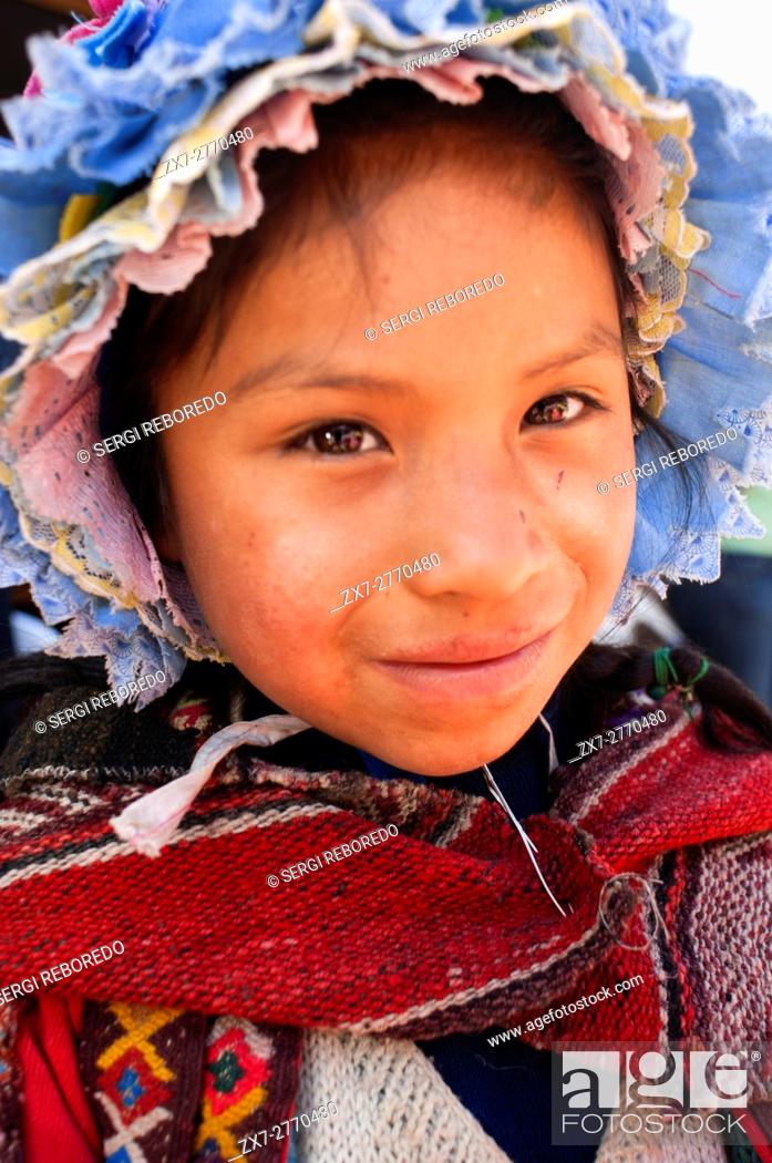 Stock Photo: Sacred Valley, Pisac, Peru. Young girl dressed in traditional costume in Pisac Sunday market day. Pisac. Sacred Valley. Pisac, or Pisaq in Quechua.